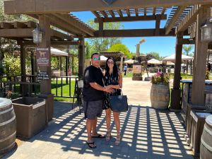 couple holding their hands and posing for a picture